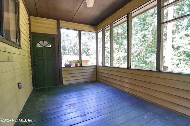 unfurnished sunroom featuring wooden ceiling and ceiling fan