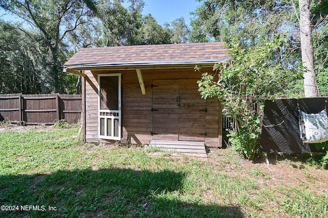 view of outbuilding featuring a lawn