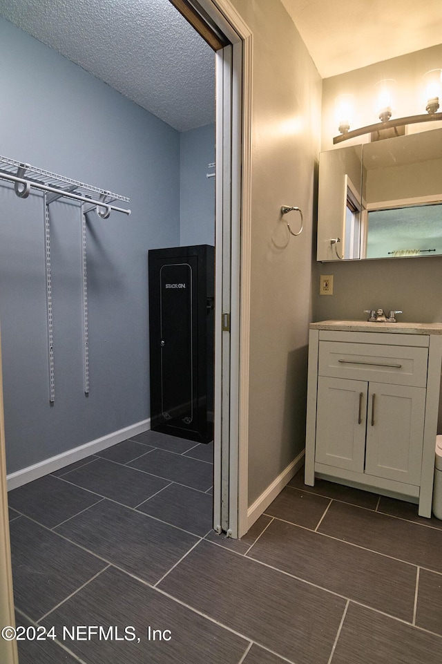 bathroom featuring vanity and a textured ceiling