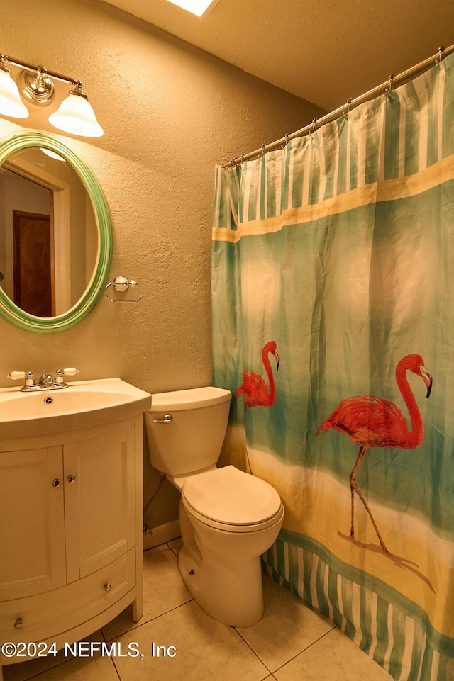 bathroom with vanity, a shower with shower curtain, tile patterned floors, and toilet