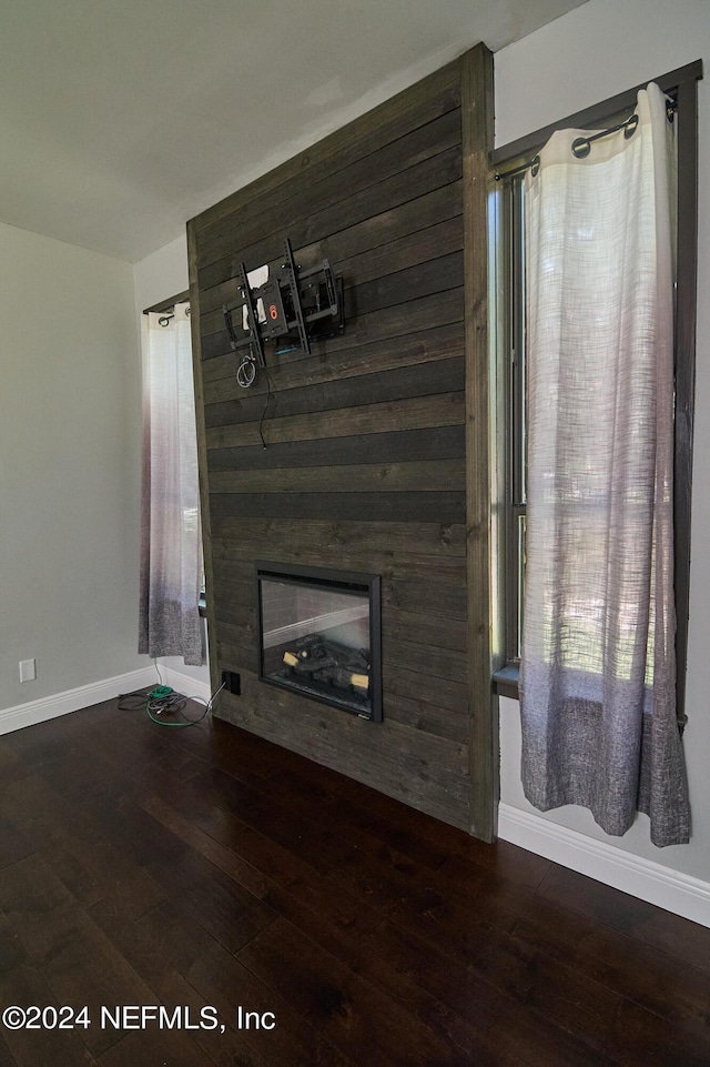 unfurnished living room with a fireplace and dark hardwood / wood-style flooring