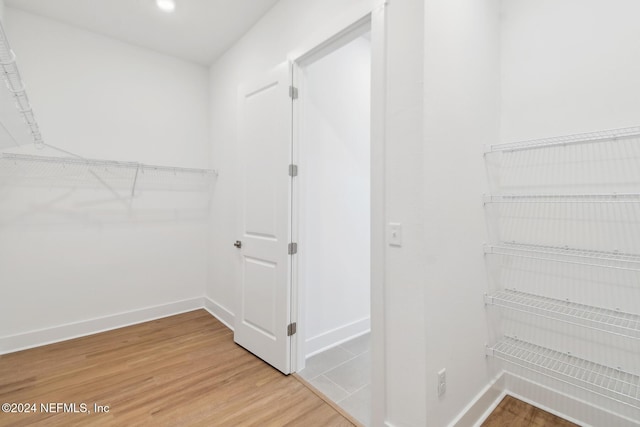 spacious closet featuring hardwood / wood-style flooring