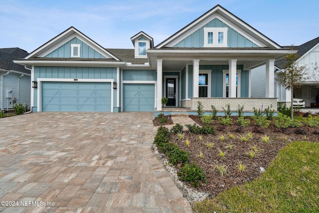 view of front of home featuring a porch and a garage