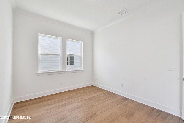 unfurnished room with light hardwood / wood-style floors and ornamental molding