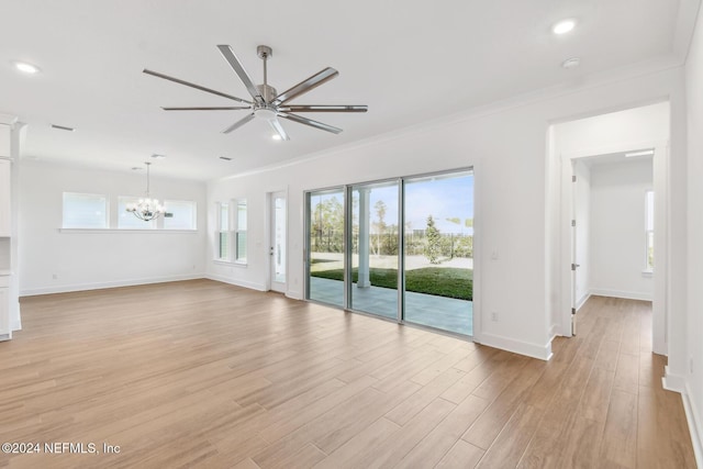 unfurnished living room with ceiling fan with notable chandelier, crown molding, and light hardwood / wood-style flooring