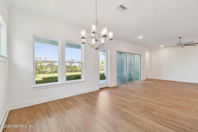 spare room featuring ceiling fan with notable chandelier, light hardwood / wood-style flooring, and ornamental molding