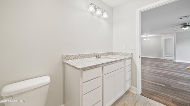 bathroom with ceiling fan, vanity, and toilet