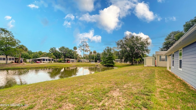 view of yard with a water view and a shed