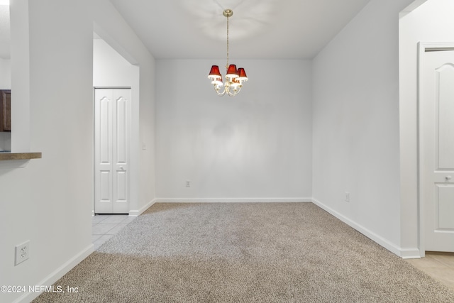 unfurnished dining area featuring light colored carpet and an inviting chandelier