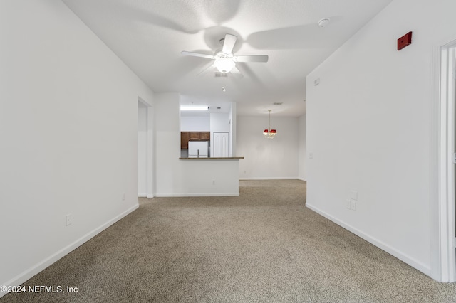 unfurnished living room featuring ceiling fan and carpet