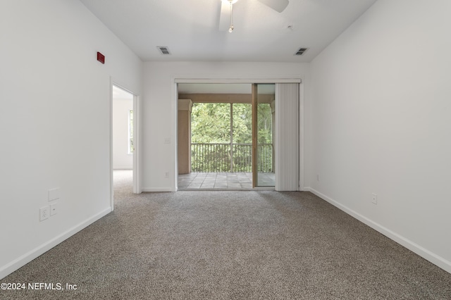 carpeted empty room featuring ceiling fan