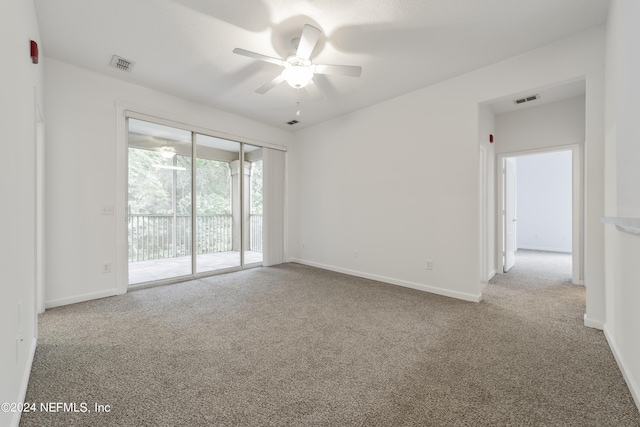 carpeted empty room featuring ceiling fan