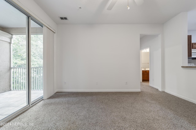 spare room with ceiling fan, a healthy amount of sunlight, and carpet flooring