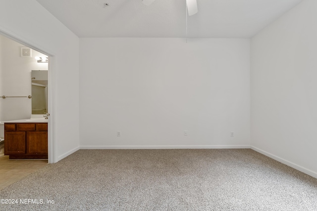 empty room with ceiling fan and light colored carpet