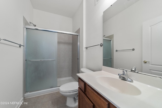 bathroom with toilet, a shower with shower door, and vanity