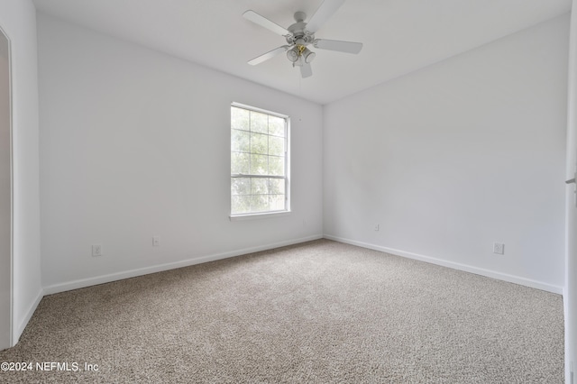 empty room with ceiling fan and carpet floors