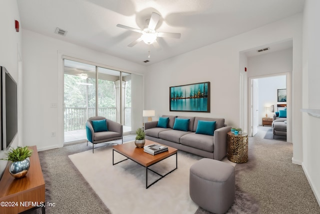 carpeted living room with ceiling fan