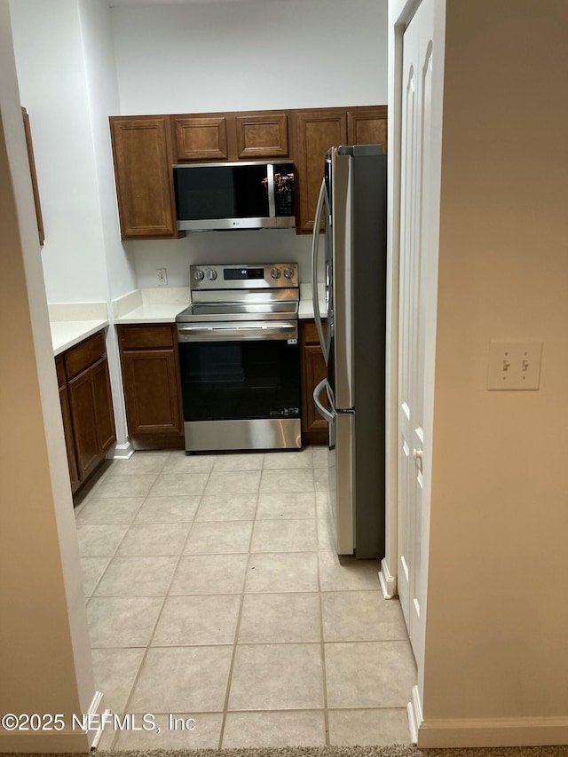 kitchen featuring light tile patterned floors and appliances with stainless steel finishes