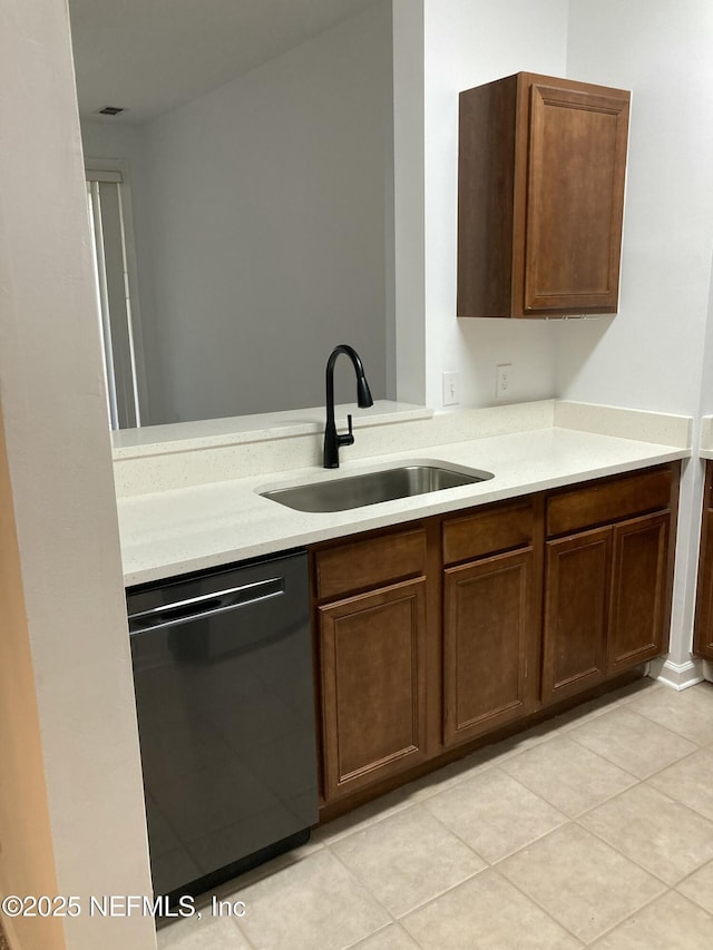 kitchen featuring sink, light tile patterned floors, and dishwasher