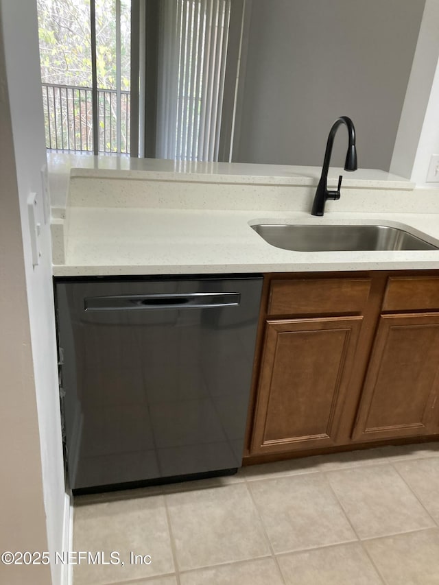 kitchen with light tile patterned flooring, dishwasher, and sink