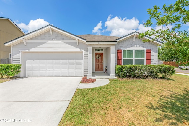 ranch-style house with a garage and a front lawn