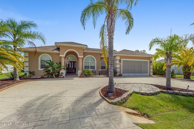 mediterranean / spanish home featuring a garage