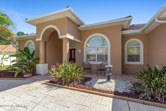 entrance to property featuring a patio