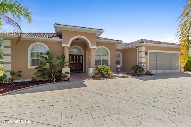 mediterranean / spanish-style home featuring a garage