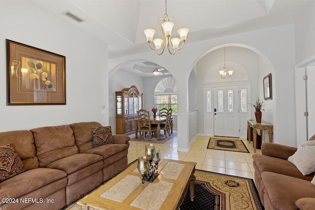 living room featuring light tile patterned floors and ceiling fan with notable chandelier