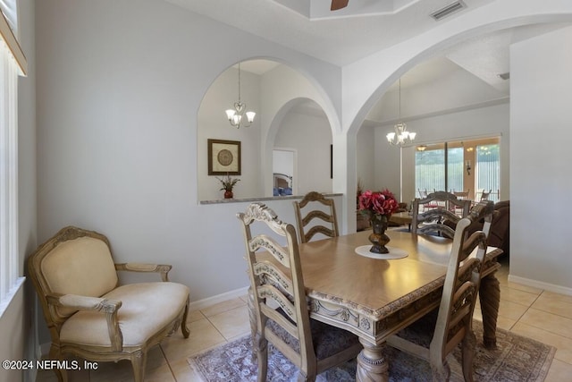 tiled dining space featuring a notable chandelier