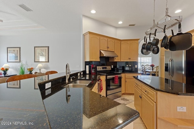 kitchen with sink, backsplash, light brown cabinetry, light tile patterned flooring, and appliances with stainless steel finishes