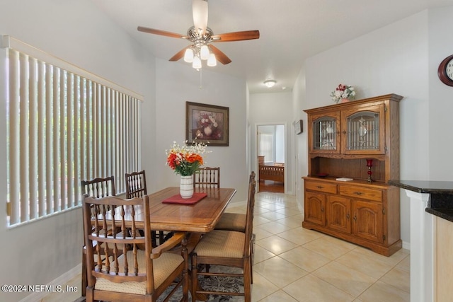 tiled dining room featuring ceiling fan