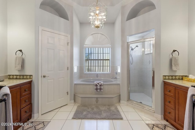 bathroom featuring tile patterned flooring, vanity, a notable chandelier, and shower with separate bathtub