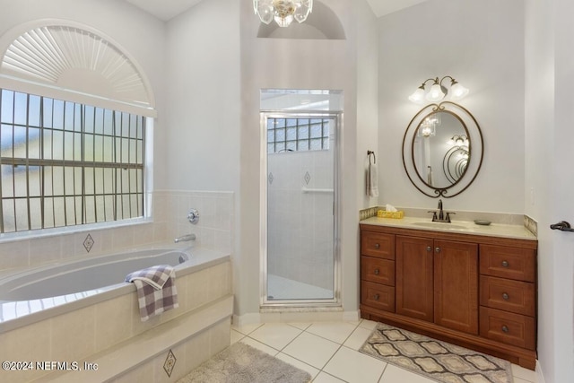 bathroom featuring tile patterned flooring, vanity, and separate shower and tub