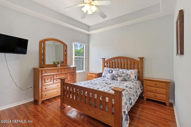 bedroom featuring dark hardwood / wood-style flooring and ceiling fan