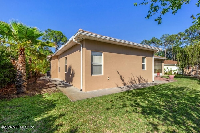 view of side of property with a yard