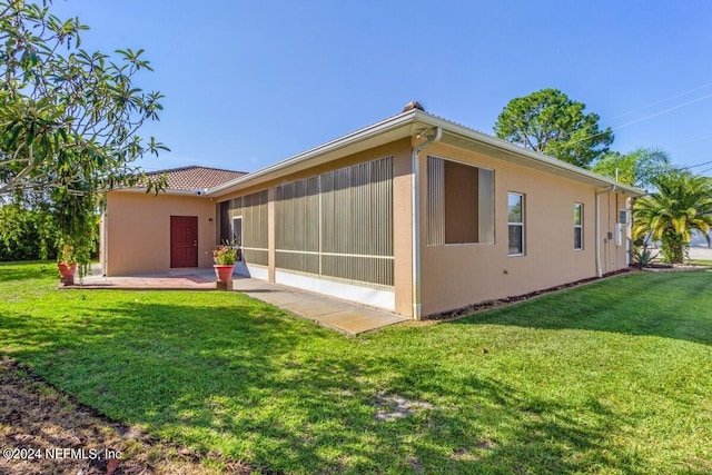 back of house with a lawn