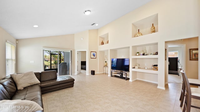 tiled living room with high vaulted ceiling and built in shelves