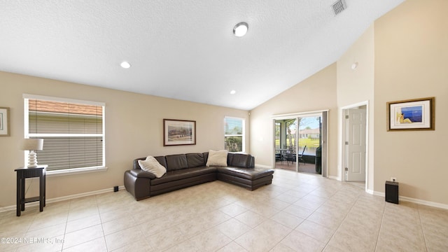 living room with high vaulted ceiling and light tile floors