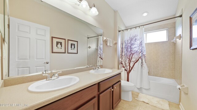 full bathroom with shower / bathtub combination with curtain, vanity with extensive cabinet space, dual sinks, toilet, and tile flooring