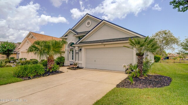 single story home featuring a garage and a front yard