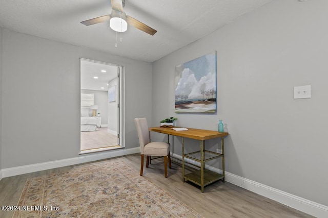 office area with ceiling fan and light hardwood / wood-style flooring