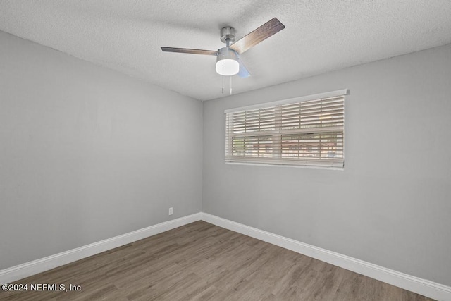 unfurnished room featuring ceiling fan, hardwood / wood-style floors, and a textured ceiling