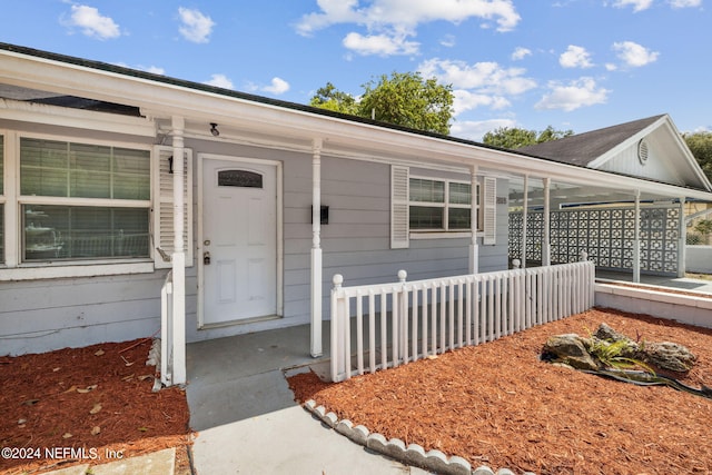 property entrance featuring covered porch