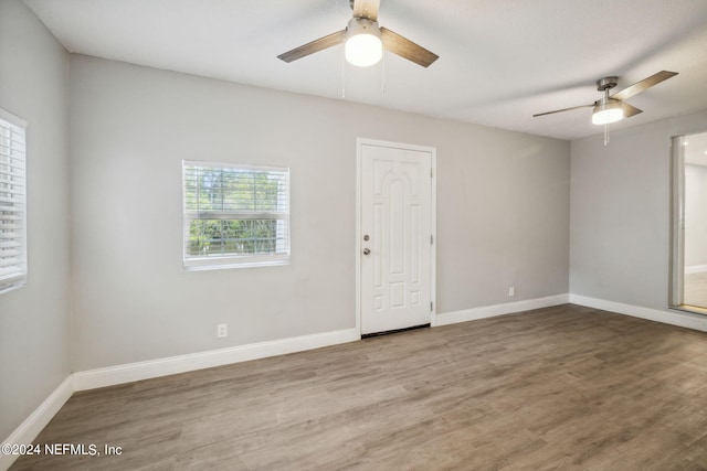 unfurnished room with hardwood / wood-style flooring and ceiling fan