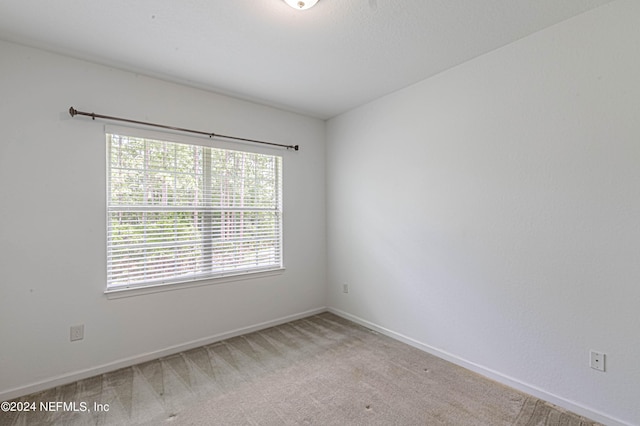 empty room featuring light colored carpet