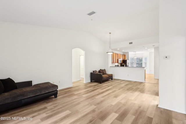 living room featuring light hardwood / wood-style flooring and vaulted ceiling