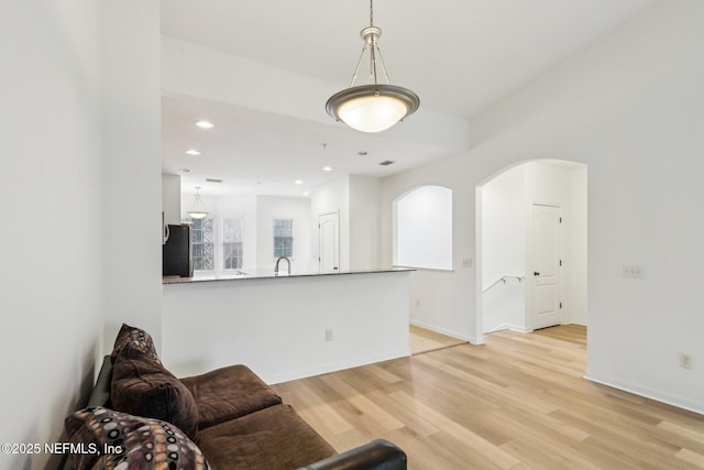 living room with sink and light hardwood / wood-style flooring