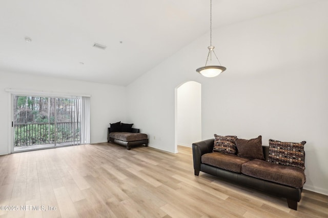 sitting room with light hardwood / wood-style flooring and vaulted ceiling