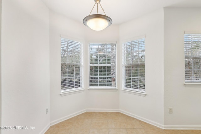 unfurnished room featuring light tile patterned floors